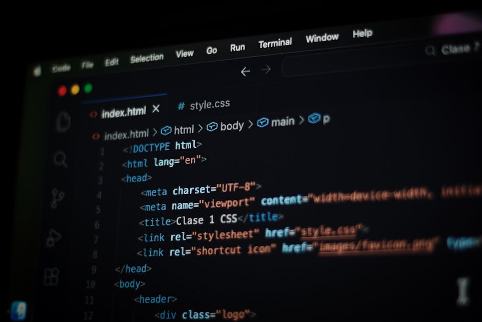 A close-up photograph of a computer screen displaying a block of colorful programming code, including lines with syntax highlighting in shades of blue, purple, pink, yellow, and white, on a dark backg